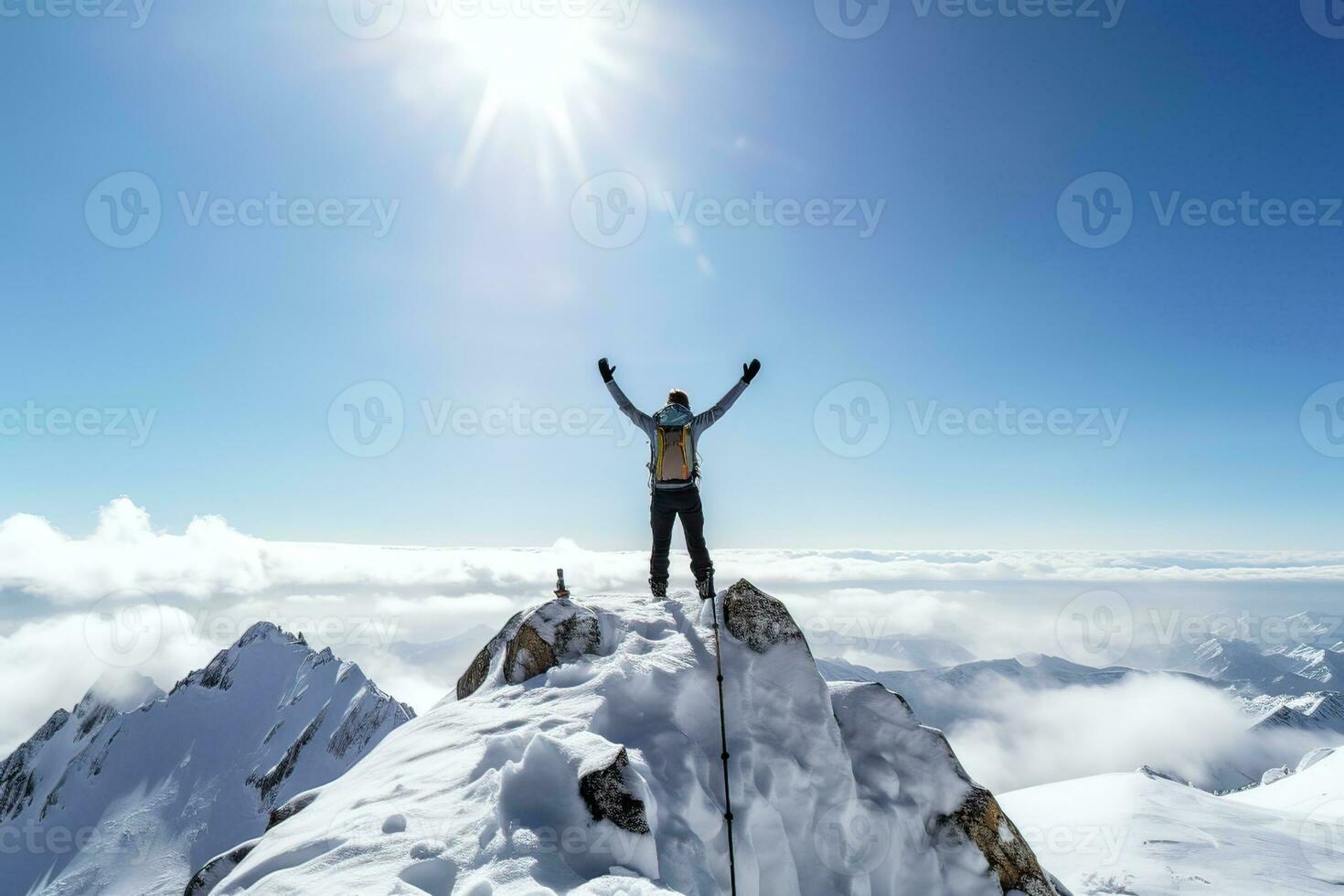 successful climber with arms raised standing on top of a snowy mountain. AI Generated. photo
