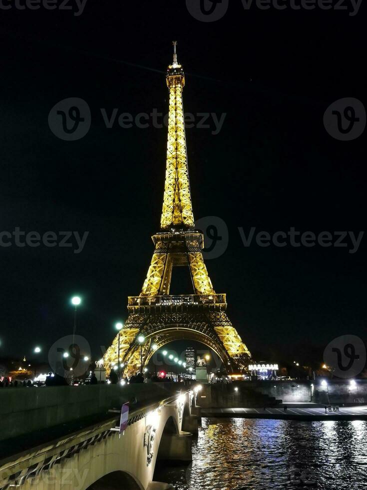 Perspective of the Eiffel Tower in Paris illuminated at the end of the day photo