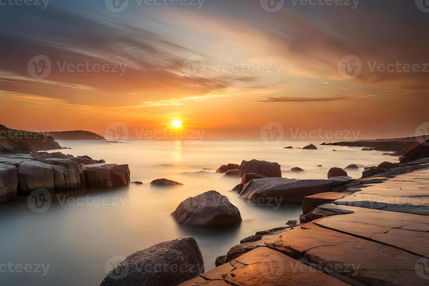 A tough rough coast washed in warm colors amid a dazzling dusk. photo