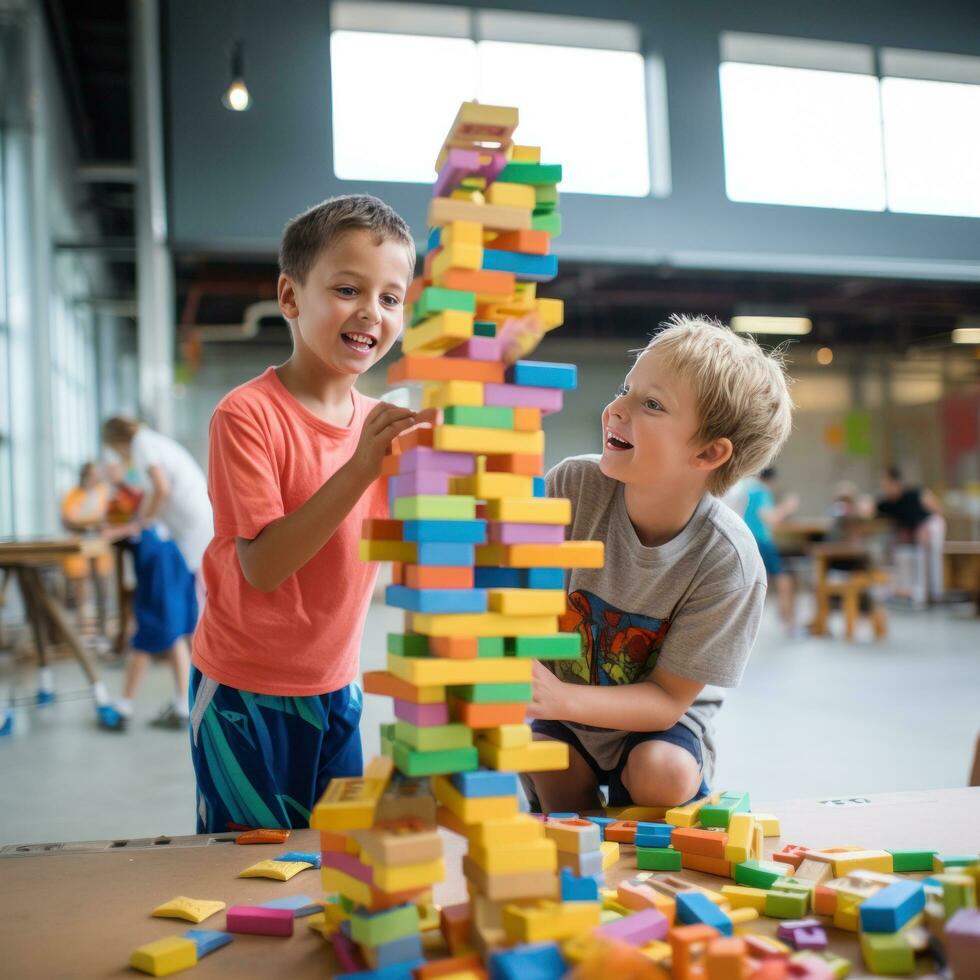 Two young boys building a towering skyscraper out of colorful blocks photo