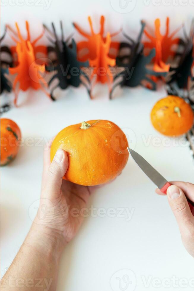 Halloween October 31st. The step-by-step process of carving a pumpkin. View from above. photo