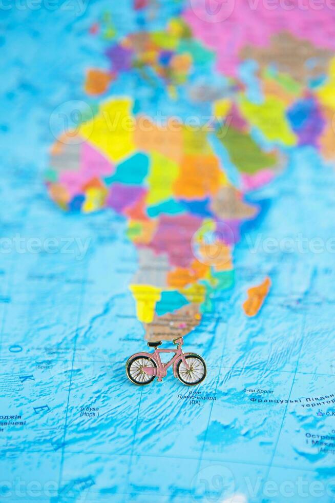 colorful mini bicycle on the world map photo