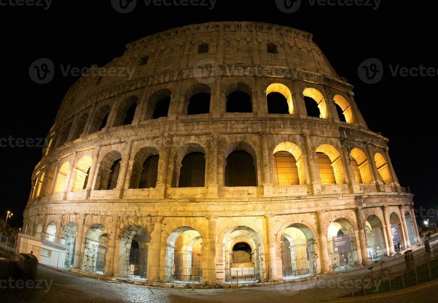 Evening Rome's Colosseum illuminated photo