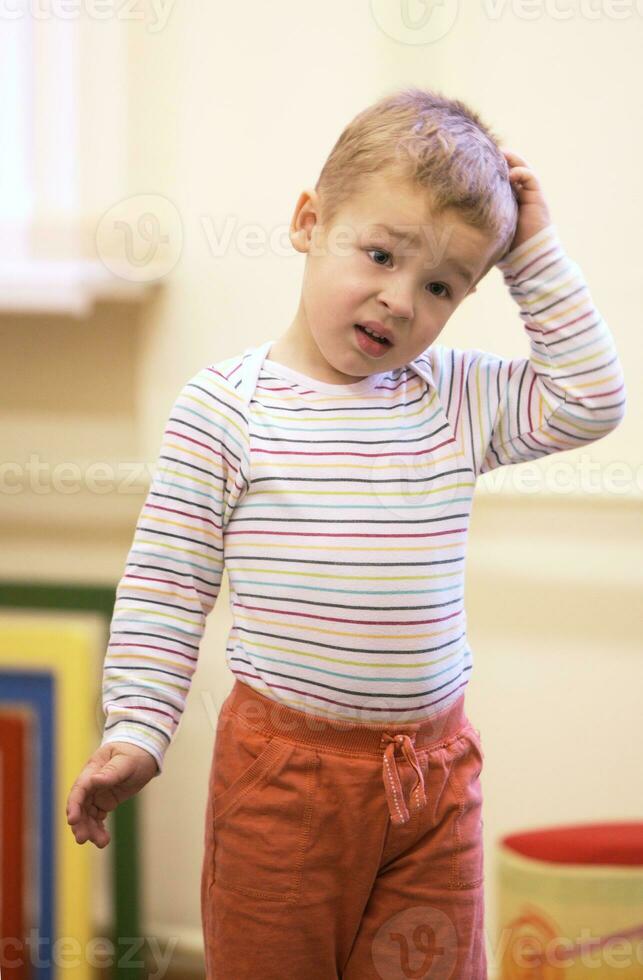 Cute little boy with a puzzled expression photo