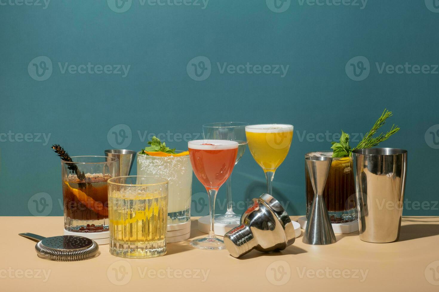 Composition with alcoholic cocktails and bar tools on podiums on colored background. Bar beverages concept. photo