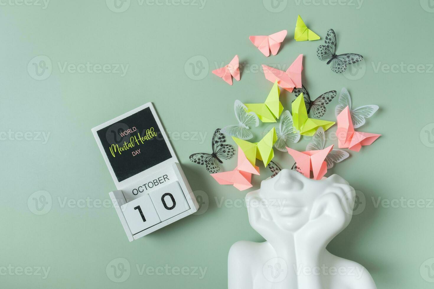 October 10 is World Mental Health Day. Head figurine with butterfly filling photo