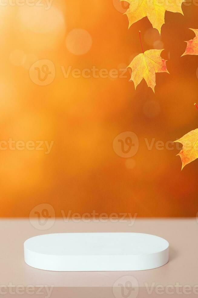 White podium and red-orange maple leaves autumn fall background with bokeh. Mock up for products. photo