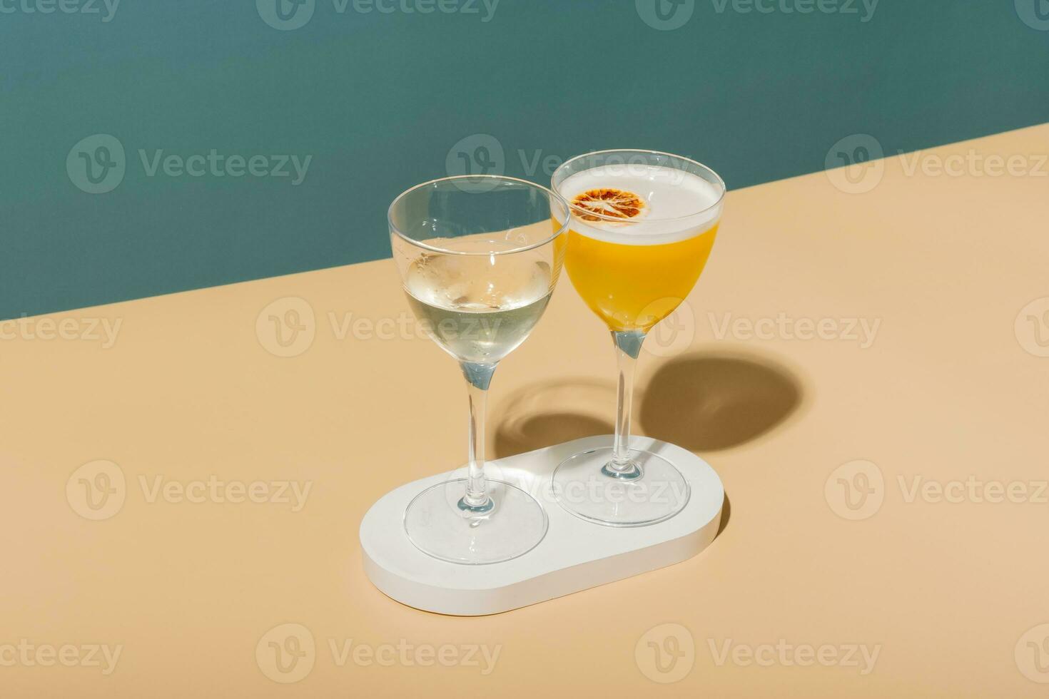 Alcoholic cocktail on a podium on a colored background. Minimalist drinks concept. photo