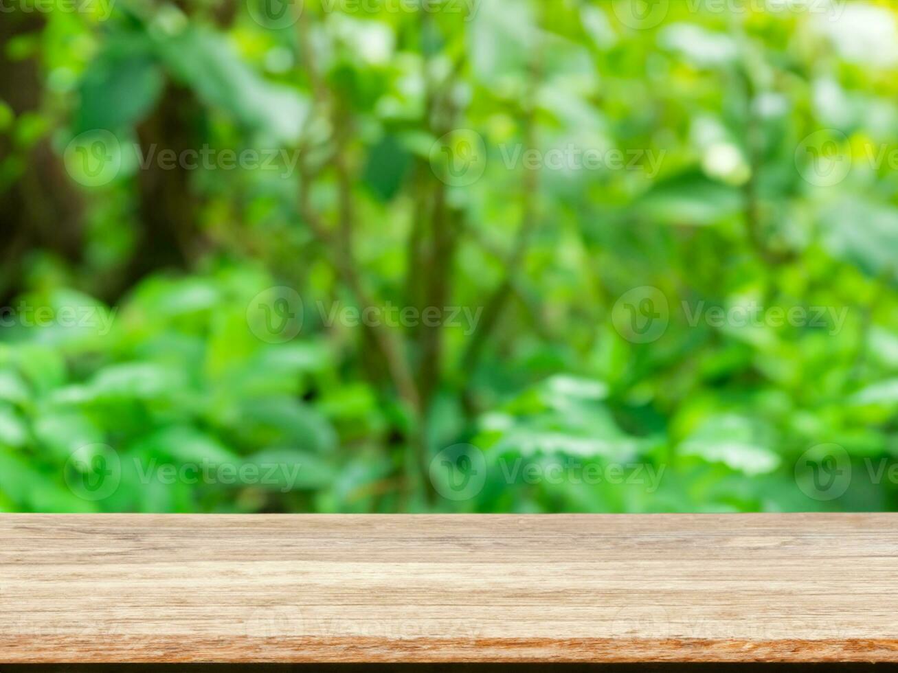 empty wooden tabletop podium in garden open forest, blurred green plants background with space. organic product presents natural placement pedestal display, spring and summer concept photo