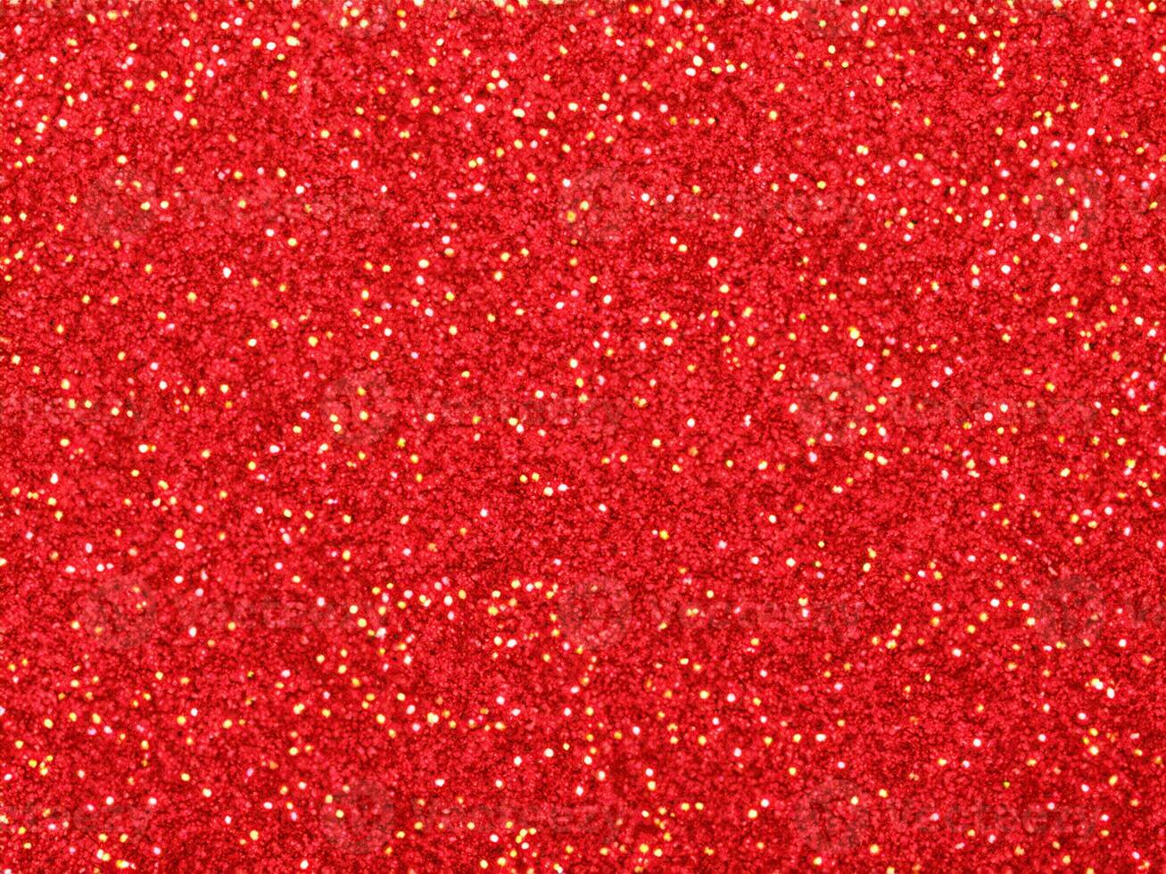 Red christmas glitter background with stars. Festive glowing blurred texture. photo