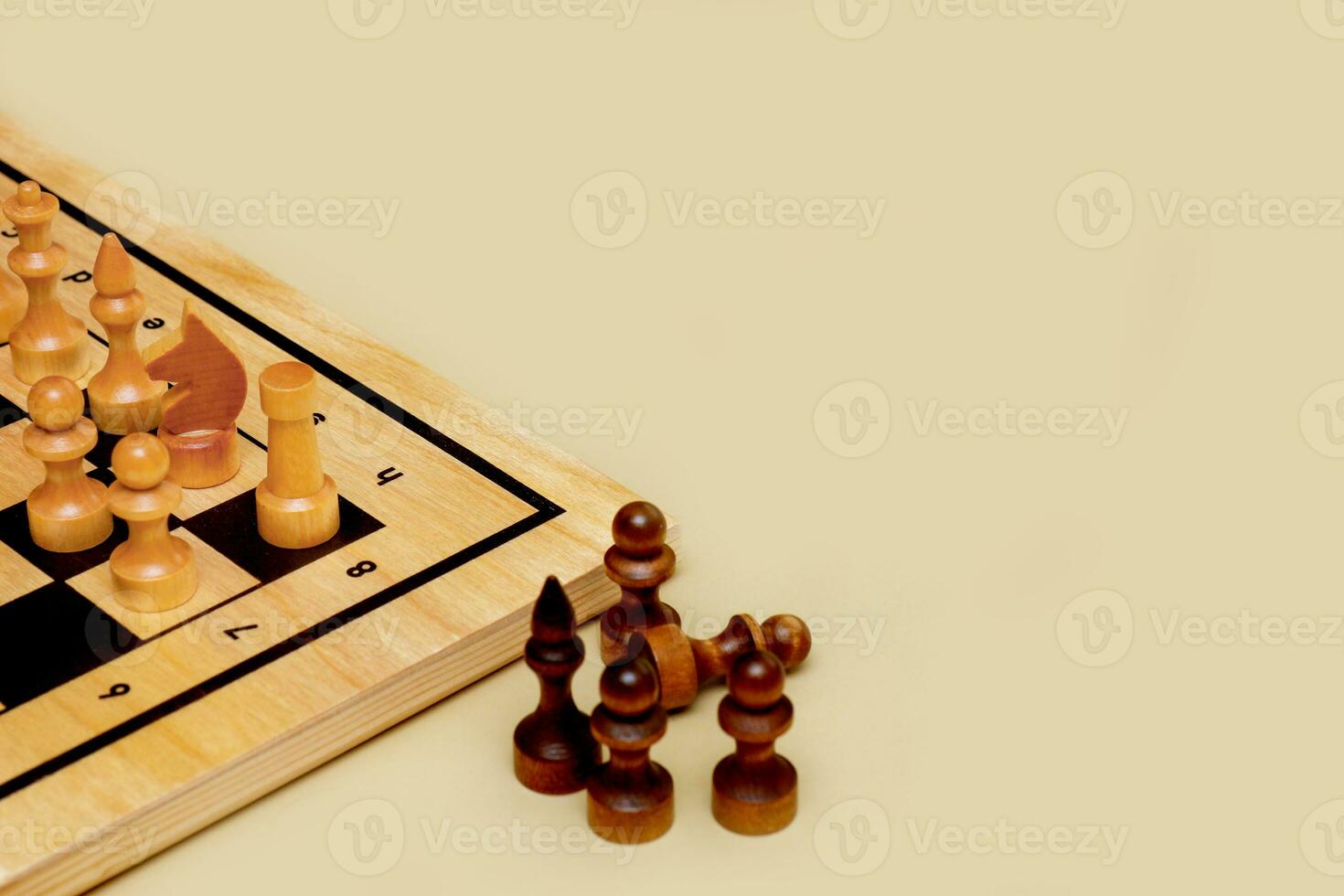 chessboard with pieces on a beige background with copy space photo