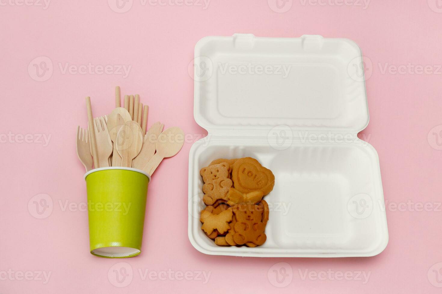 honey cookies in lunchbox and paper glass with disposable cutlery photo