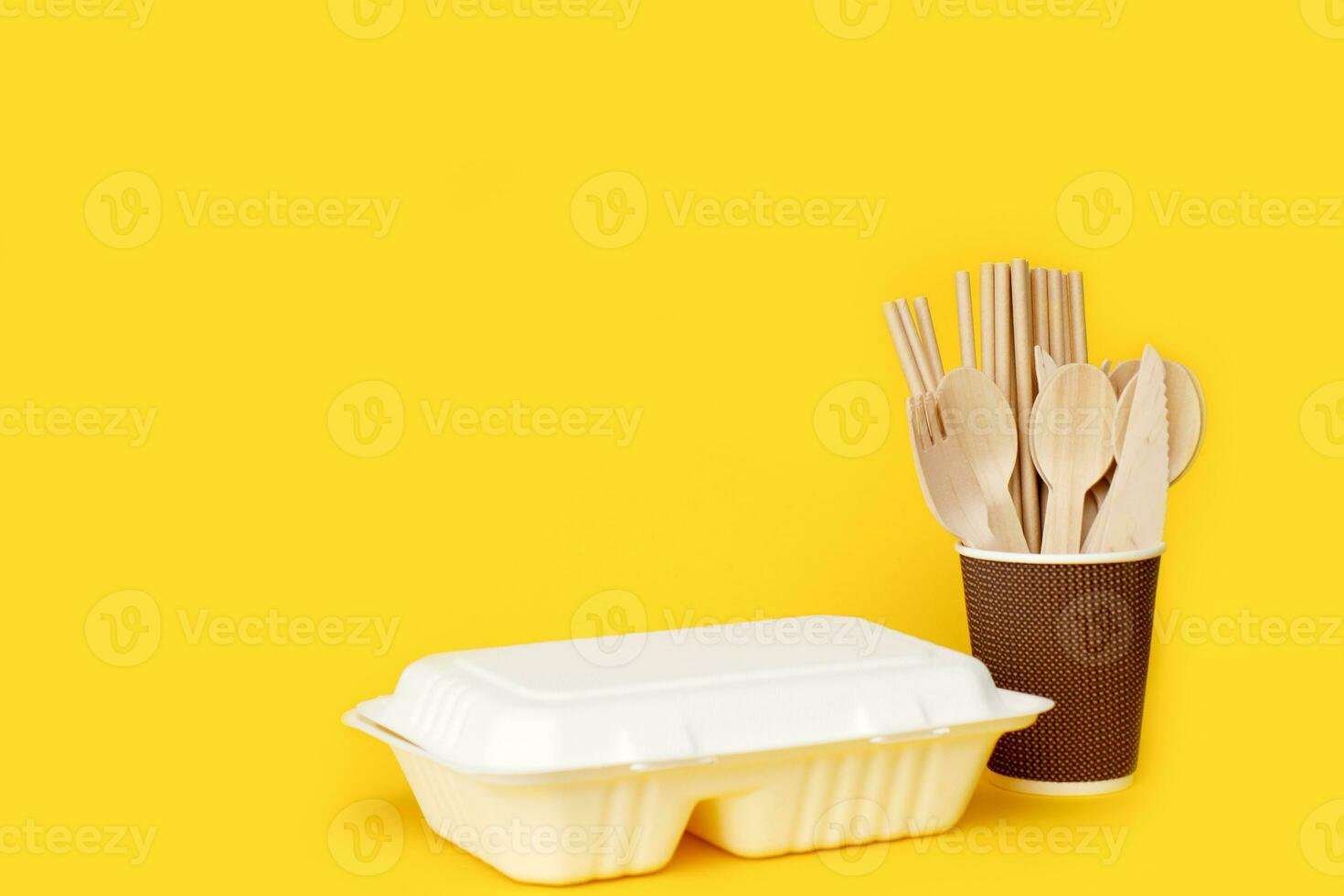 lunch box with disposable cutlery in a paper cup with copy space photo
