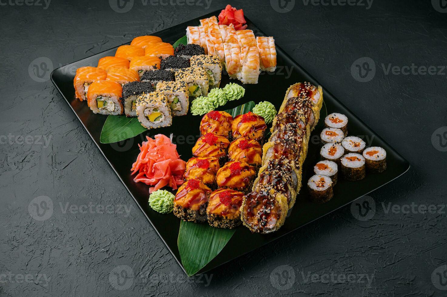 Japanese sushi assorted on a black stone plate photo