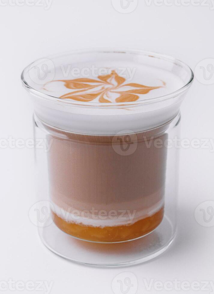 Glass of delicious latte macchiato isolated on white photo