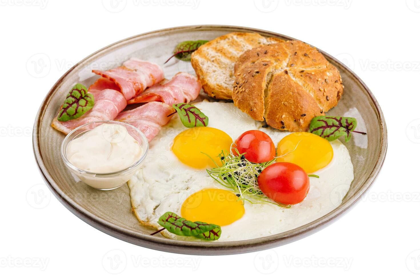 Plate of breakfast with fried eggs, bacon and toasts isolated on white photo