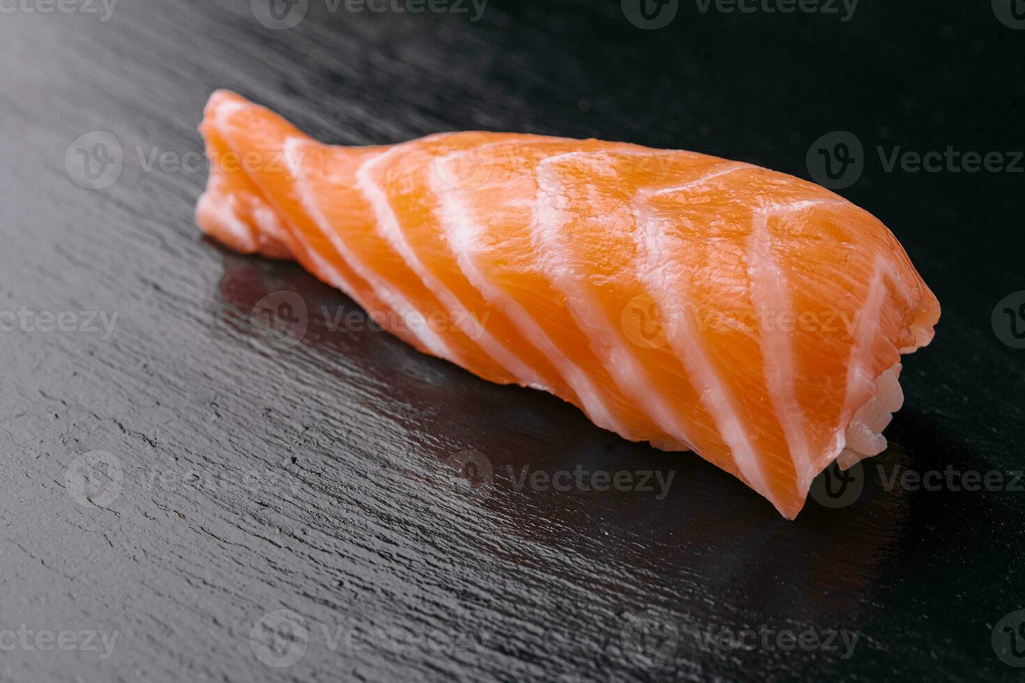 japanese salmon sushi on black wood table photo