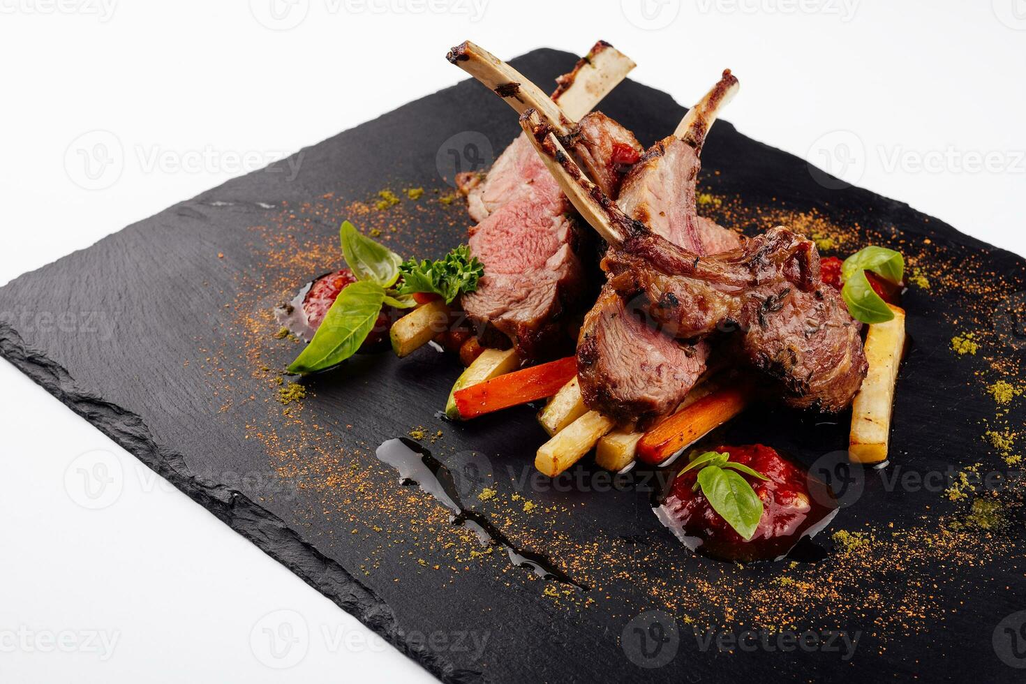 roasted lamb rack served with carrot, yellow curry and lamb sauce photo