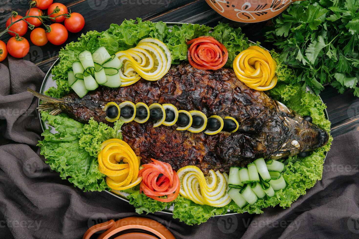 baked carp with vegetables close-up in a baking dish on the table photo