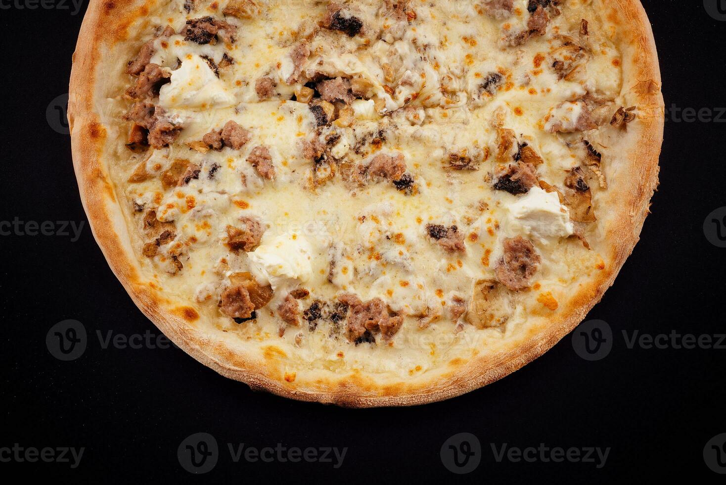 Tasty pizza with fresh ingredients on black photo