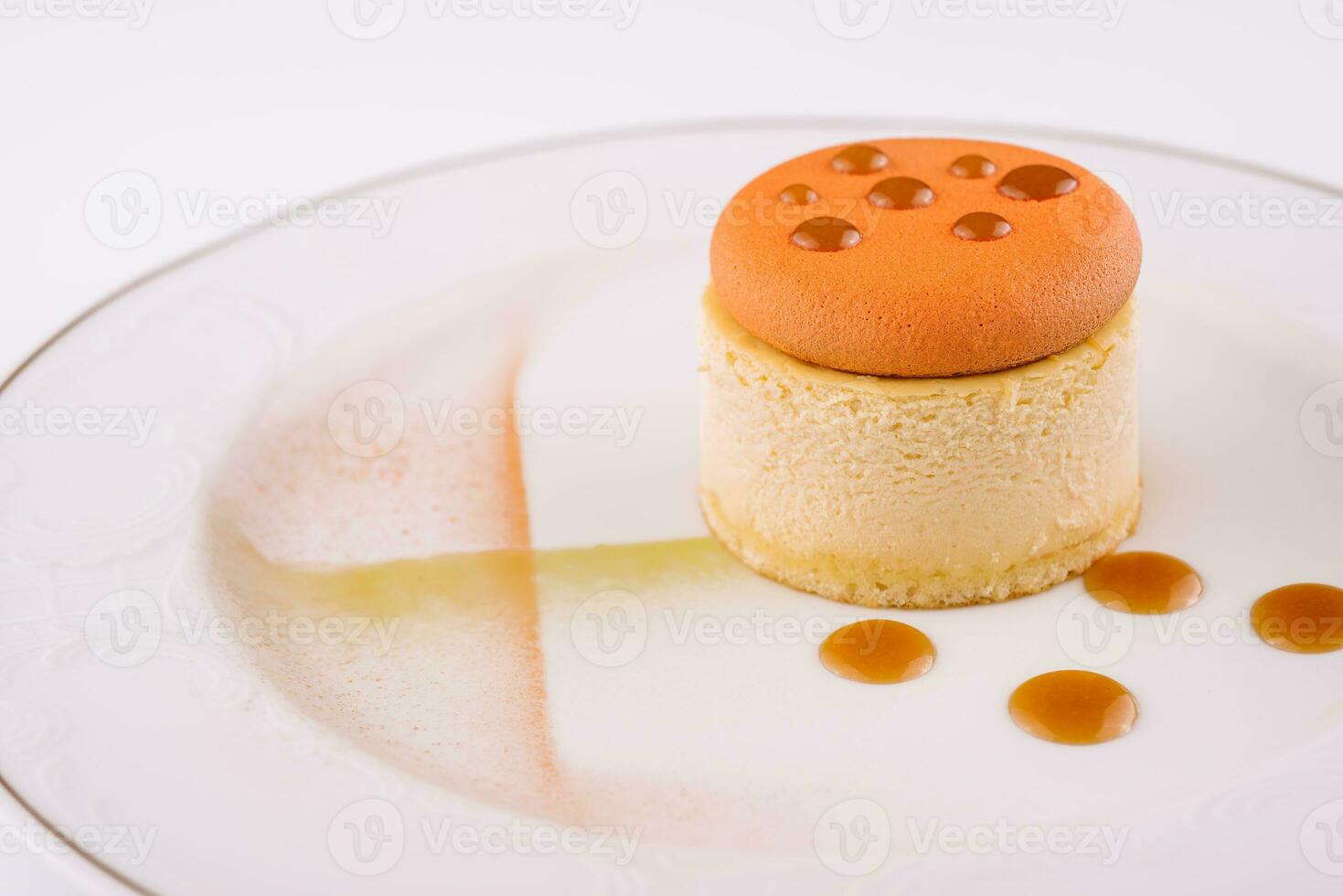 Piece of delicious cake with caramel on white plate photo
