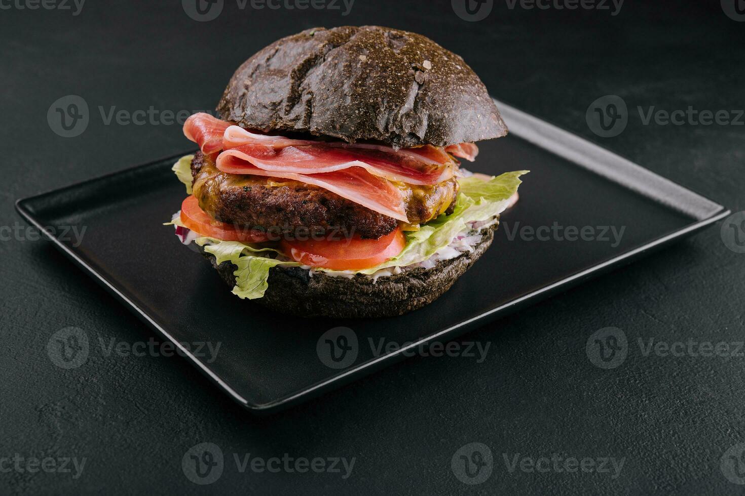 Modern black burger with prosciutto ham photo