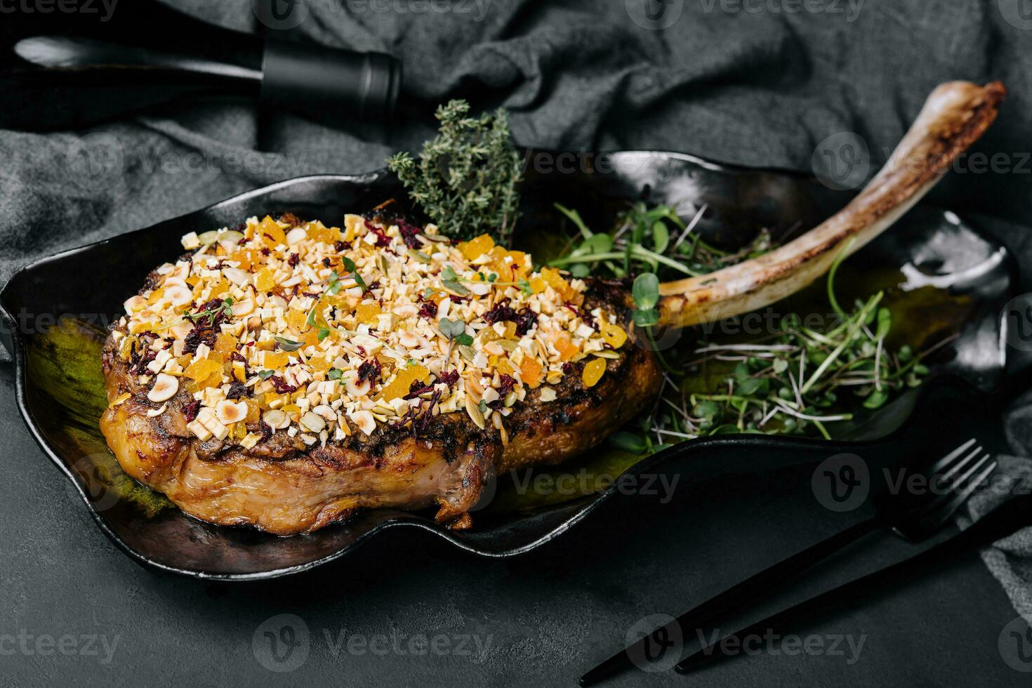 Barbecue tomahawk steak on black plate photo