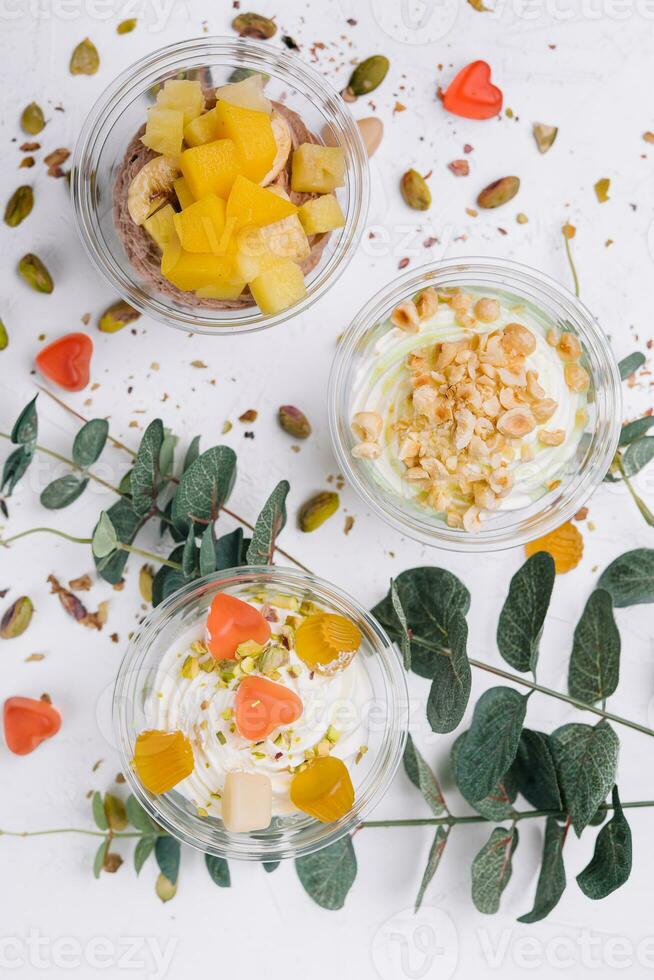 Soft chocolate and vanilla ice cream with pistachio, mango and jelly photo