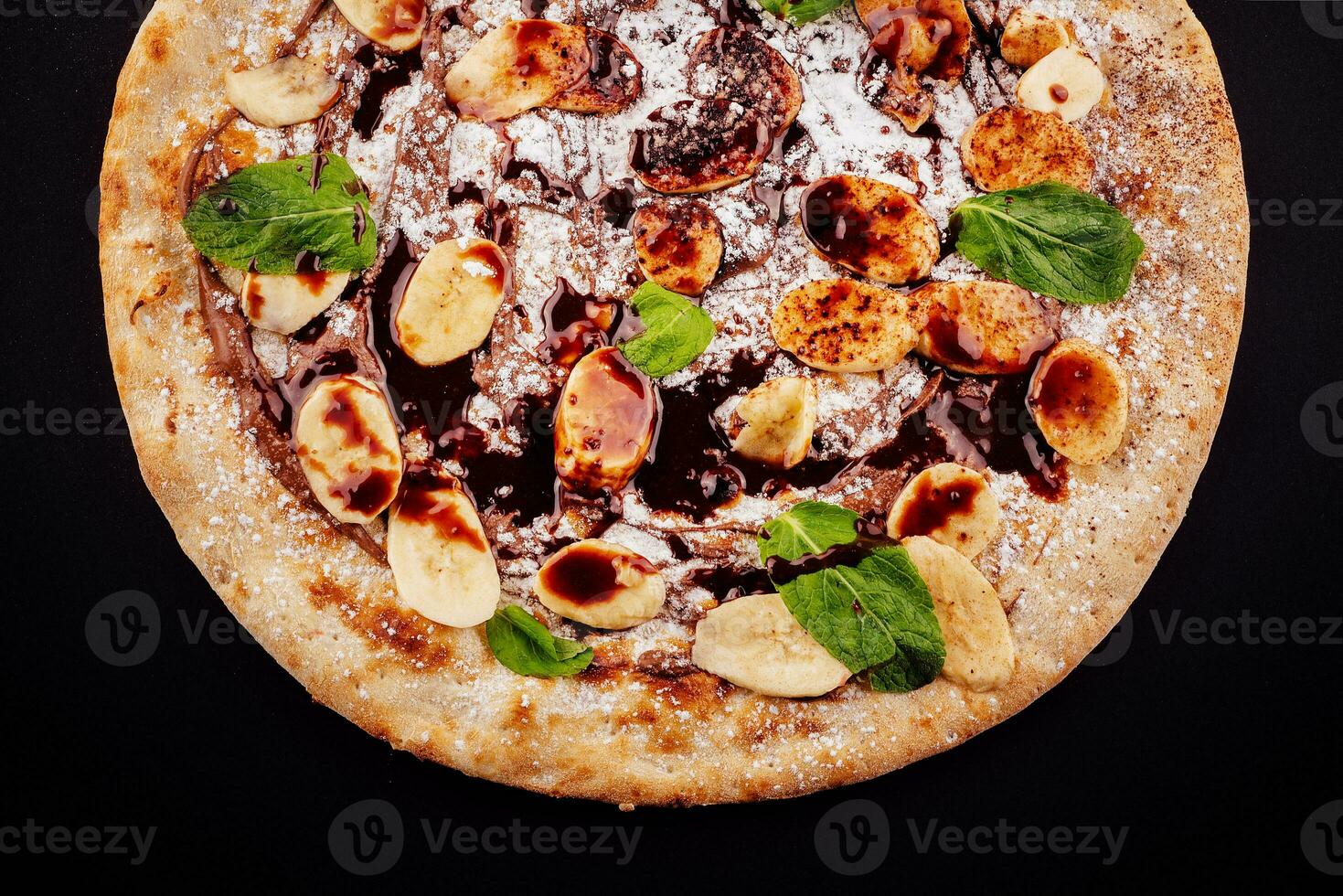 Tasty hot italian pizza for children with banana, chocolate and coconut photo