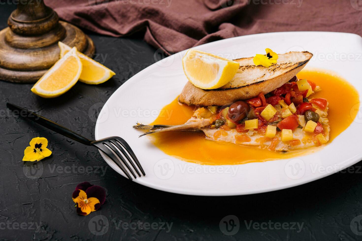 Tasty piece of bread with fried trout fillet photo