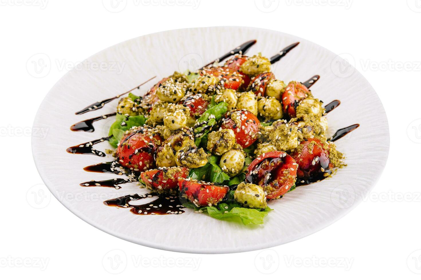 salad with tomatoes and mozzarella cheese with basil leaves and strips of soy sauce photo