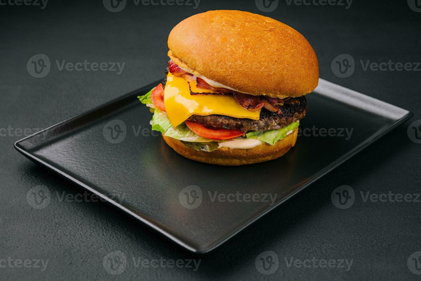 Close up tall tasty burger with cheese served on tray photo