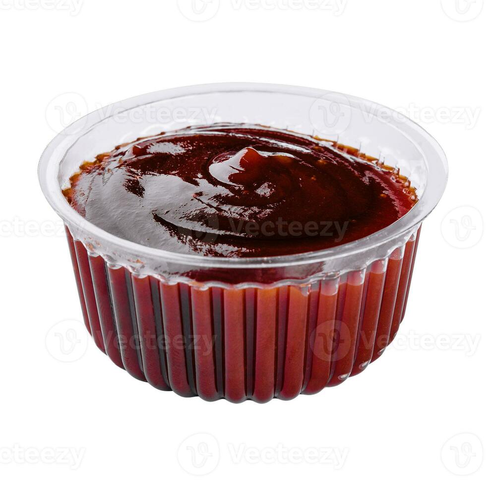 plastic dish of barbecue sauce on white background photo