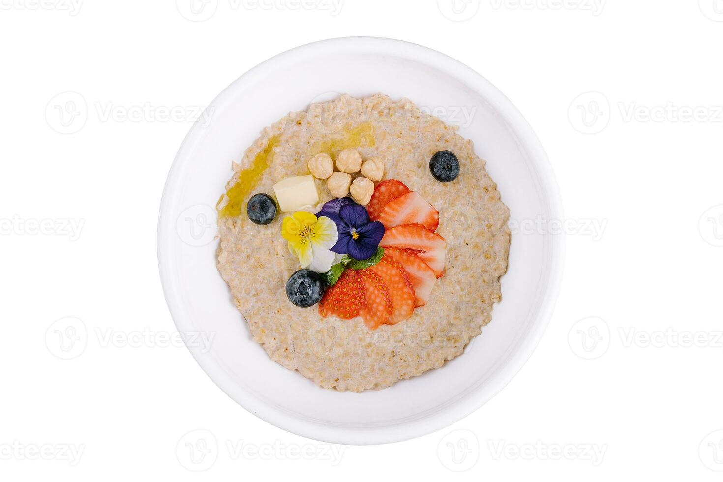 Oatmeal porridge with blueberries, strawberries and hazelnuts photo