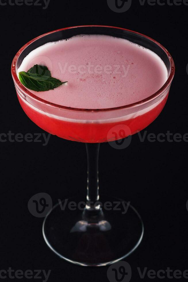 Red, sweet berry cocktail with froth photo