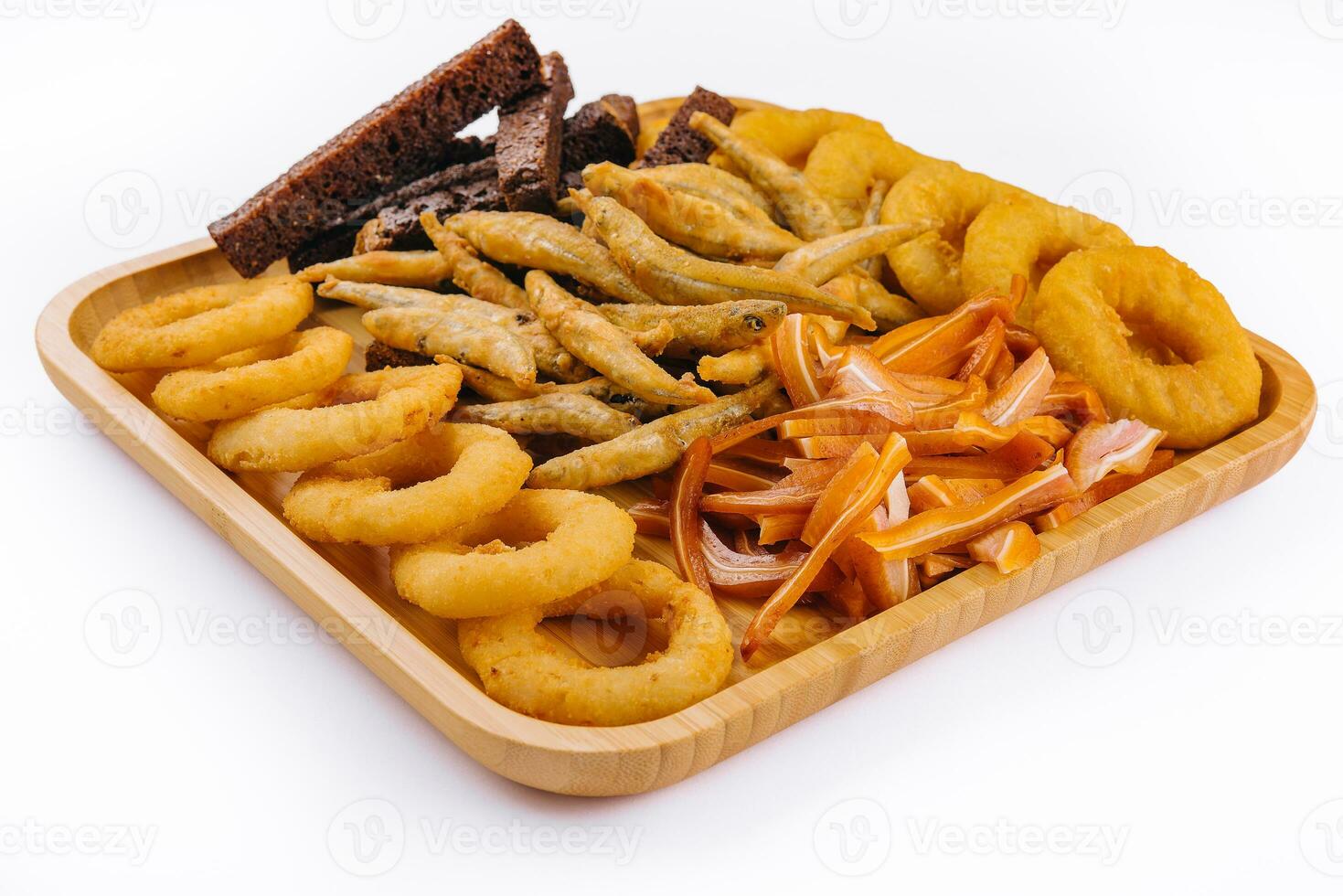 onion rings, fried smelt, pork ears on board photo