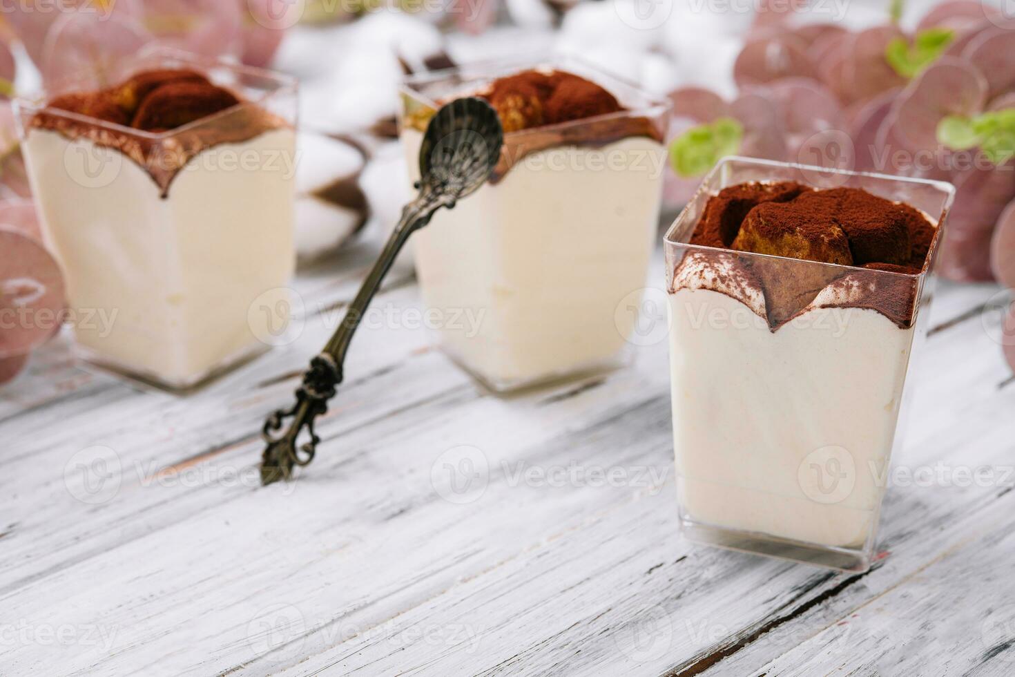 Traditional italian dessert tiramisu in a glass photo
