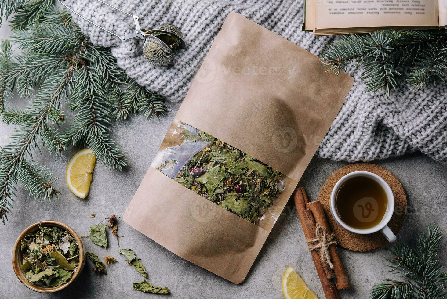 Hot tea in a cup with dried tea in a package photo