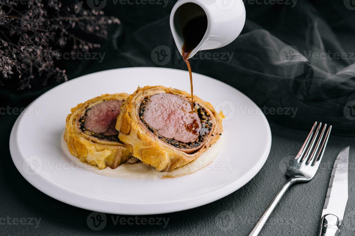 Fillet wellington in puff pastry on plate photo