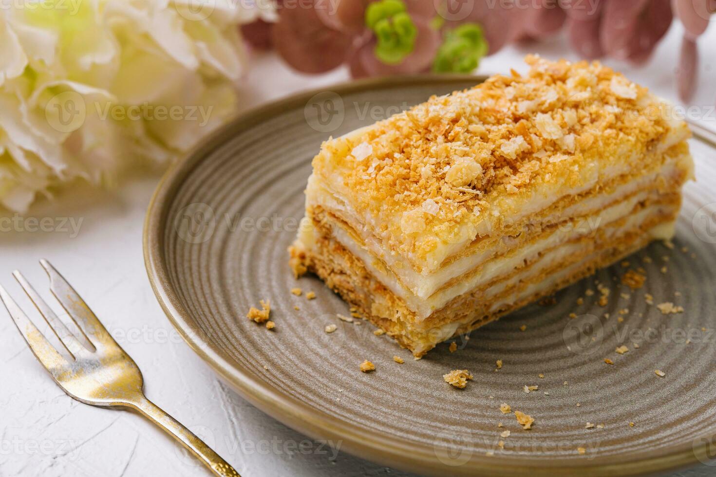 Napoleon cake on plate on table close-up photo