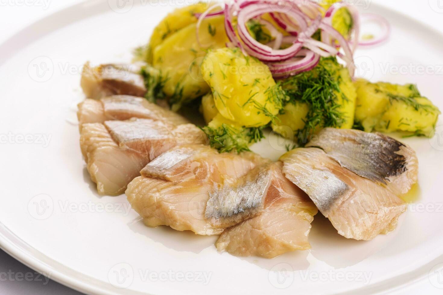 Salted fish with boiled potato and pickled onions photo