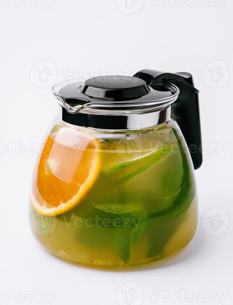 Jug of tasty cold tea on white background photo