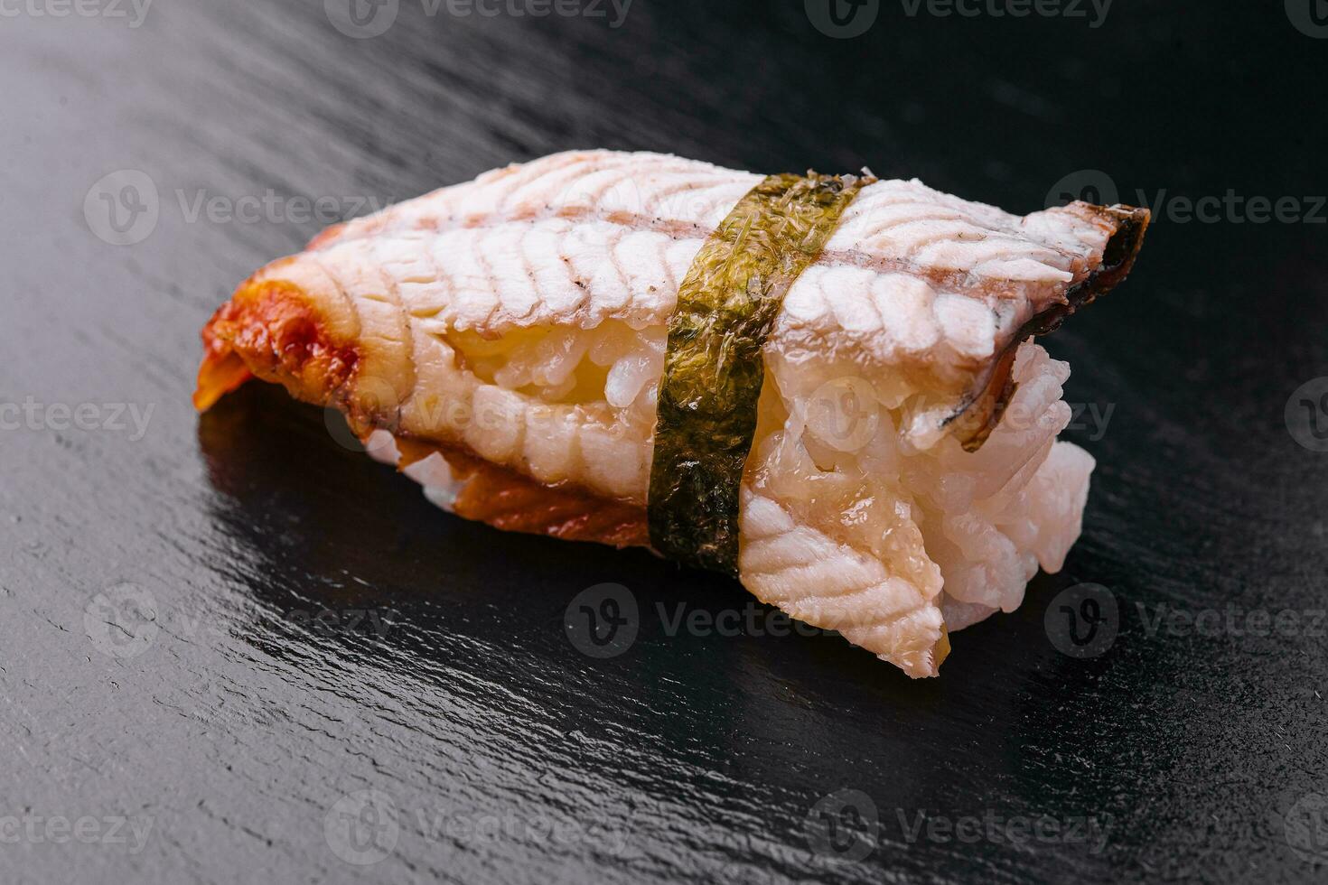 Eel sushi on black wooden board photo