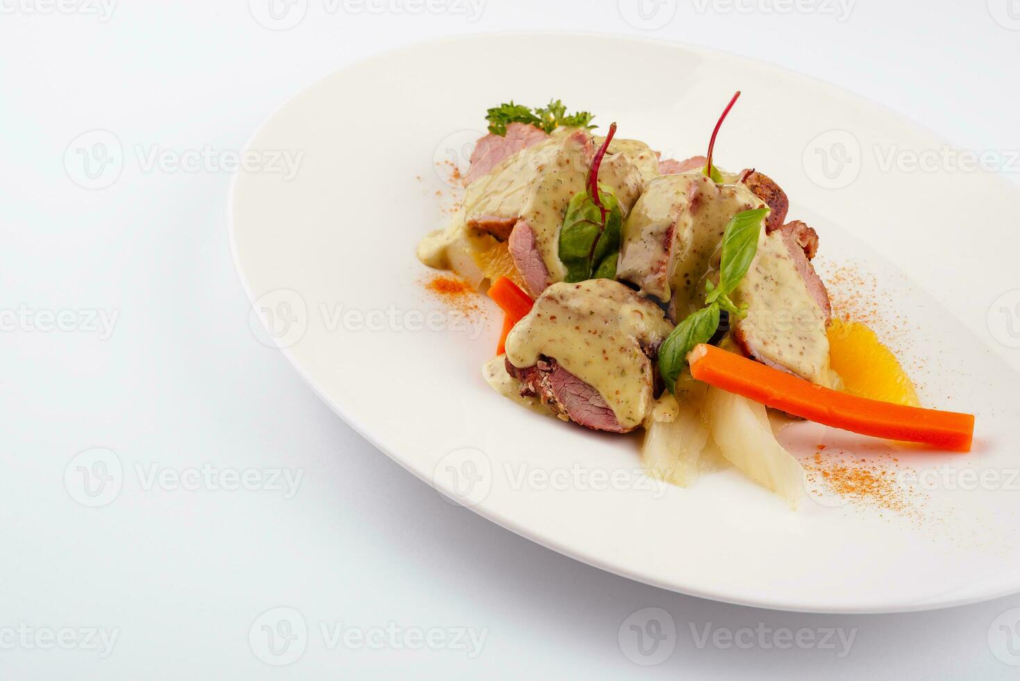 Roasted duck with white sauce on plate photo