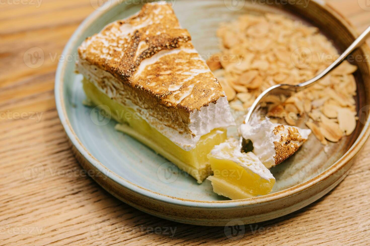 Yummy lemon meringue pie on plate photo