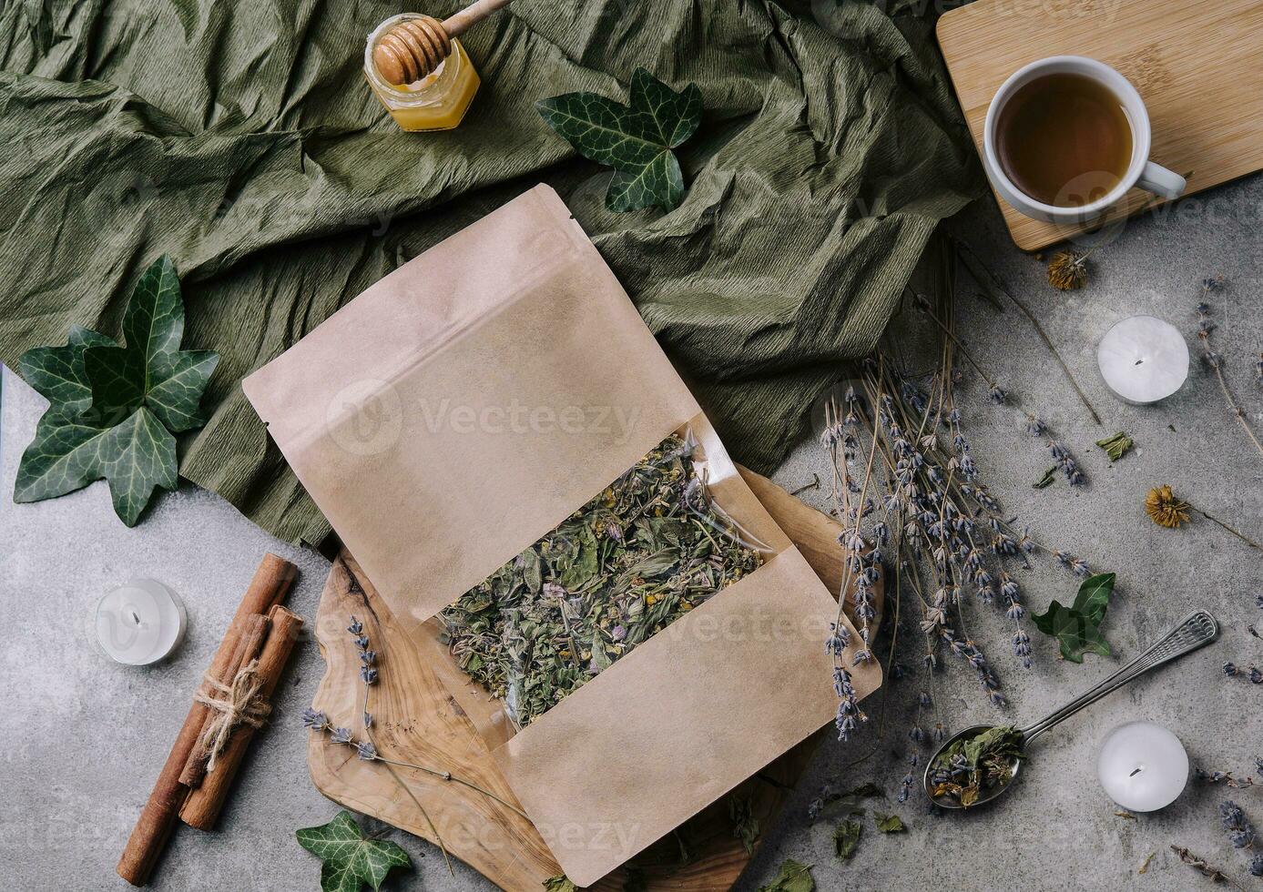 Dried and fresh tea leaves with tea, honey and cinnamon photo