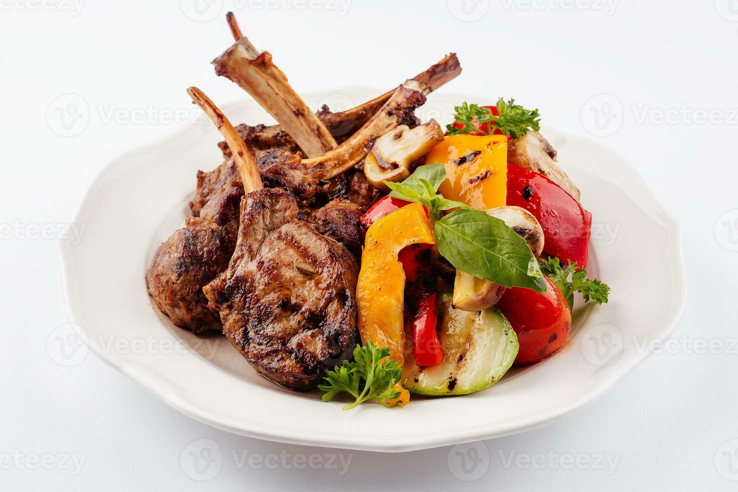 Grilled lamb rack with baked vegetables photo