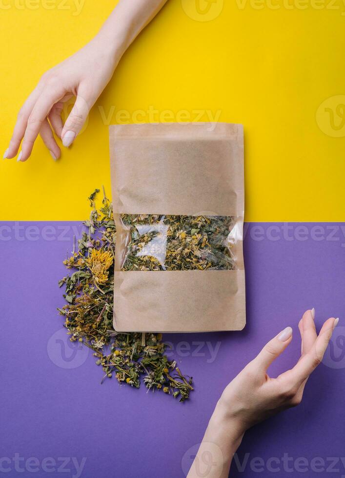 Paper bag with dry loose leaf tea photo