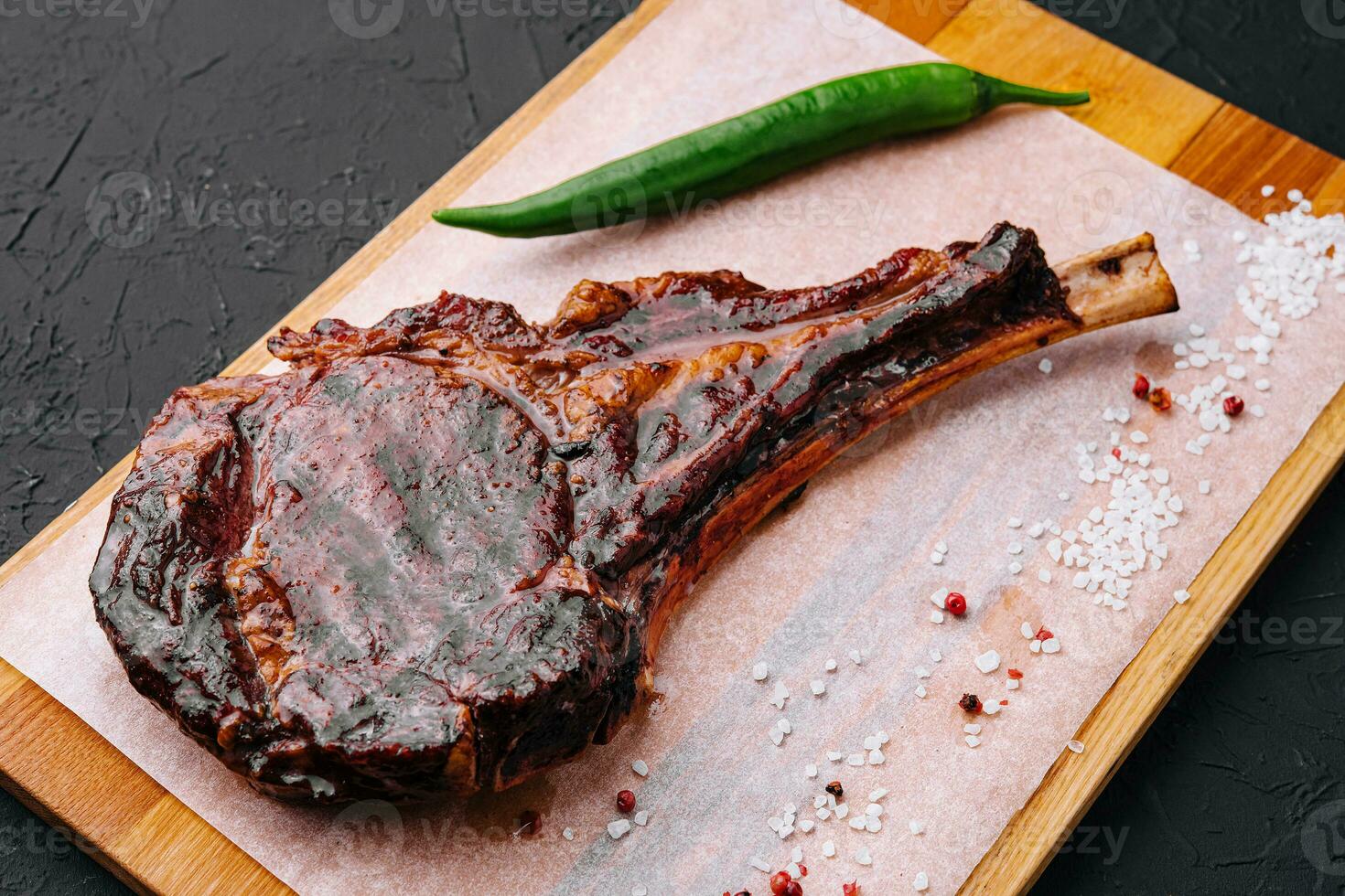 Grilled pork steak on wooden board photo