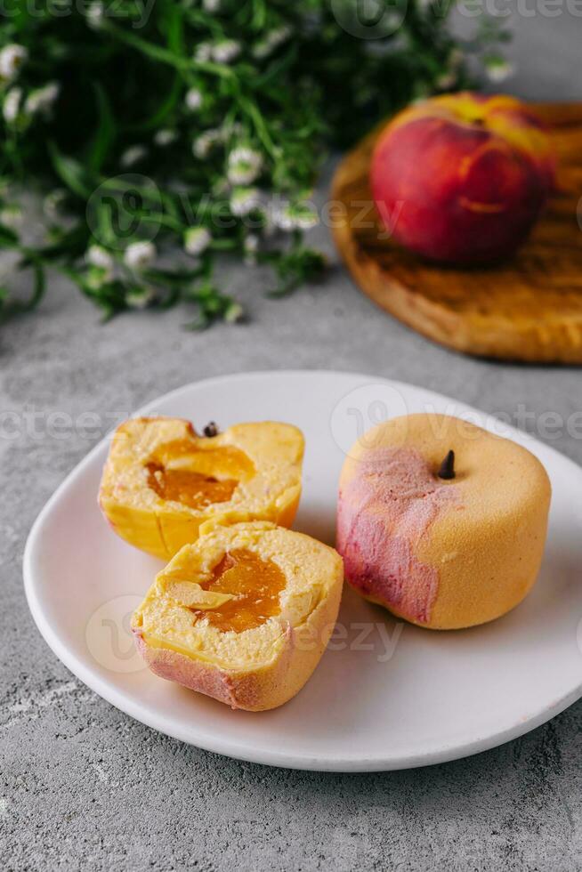 Two small french mousse cake apple shaped dome served on a plate photo